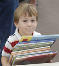 Boy checking out books