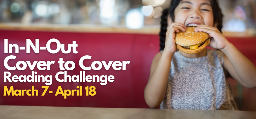 Image of a girl eating a cheeseburger at a diner table