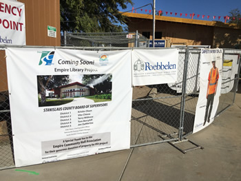 The coming soon sign on the cylone fencing around the construction site of the new Empire Library.