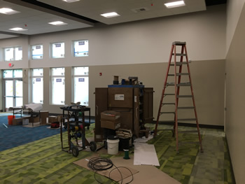 The interior of the main area of new Empire Library. Includes blue and green carpet,and beige and tan walls.