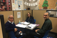 Adults around a table for tutoring