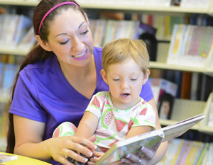 Mom reading to child at the library