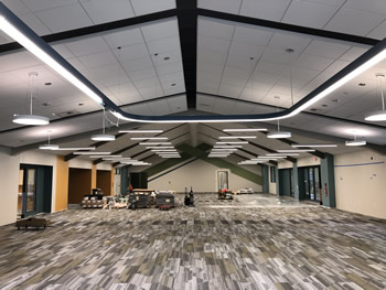 The interior of the main area of the library with the celing, lighting, and carpet installed.