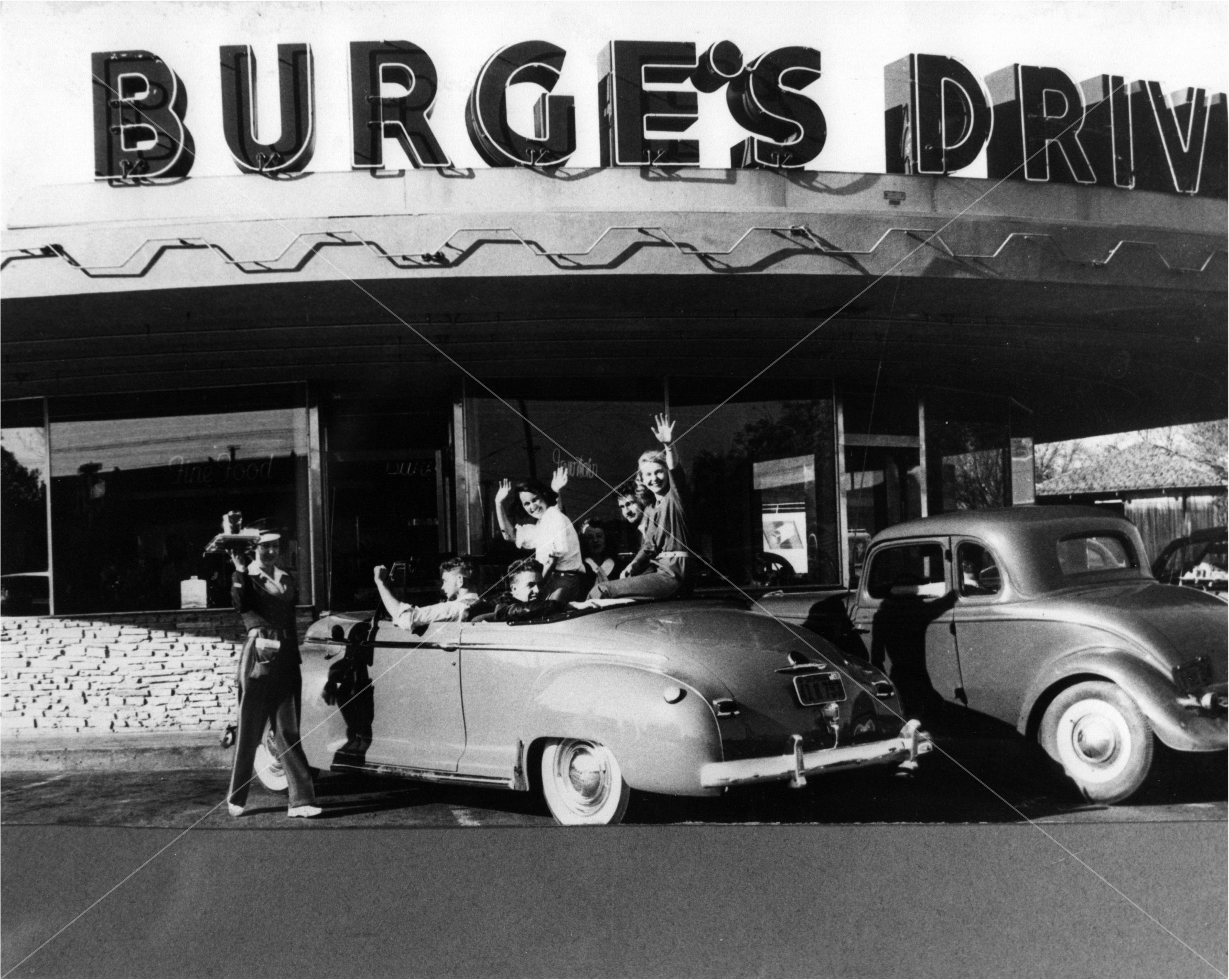 People at Burge's drive-in waving